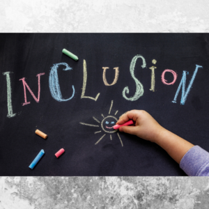 A chalkboard background with a child's arm drawing a sun with a smiley face. Above this written in different coloured chalk is the word inclusion. Pieces of different coloured chalk are also scattered around.