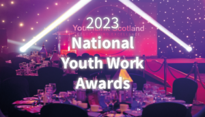 Pink and purple image of awards set up with text 2023 National Youth Work Awards on top